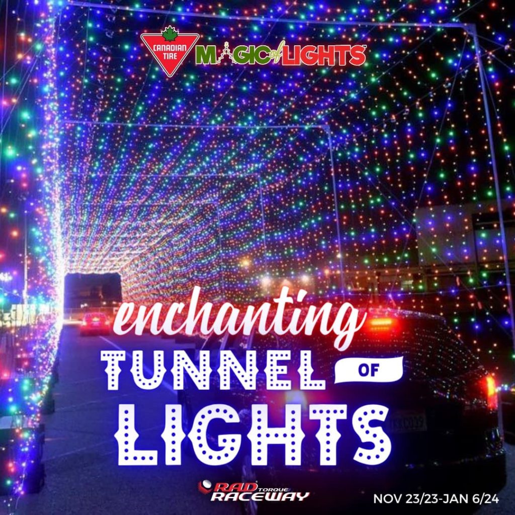 2 cars driving through large tunnel of Christmas lights